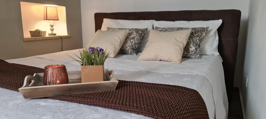 ein Bett mit Kissen und ein Tablett mit Blumen darauf in der Unterkunft La Casetta in Bagheria