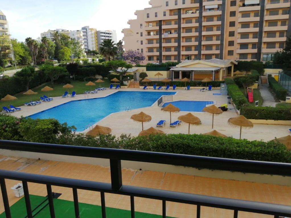 a view of the pool from the balcony of a hotel at Club Amarílis,Alex&Mila Aparthotel Praia da Rocha in Portimão