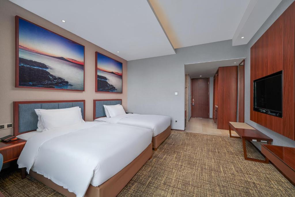 Кровать или кровати в номере Ausotel Smart Baiyun International Airport T2