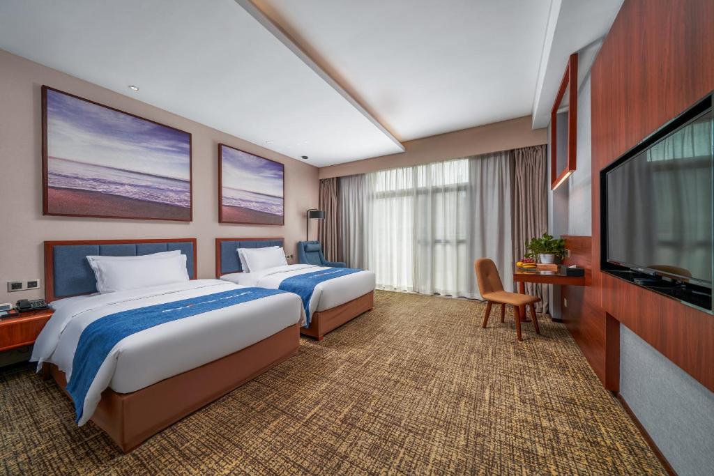 Кровать или кровати в номере Ausotel Smart Baiyun International Airport T2