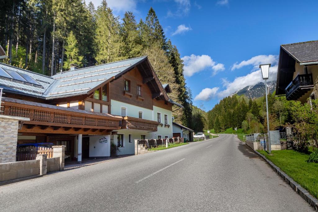 an empty road in a mountain village with houses at Four Seasons Lodge in Lackenhof