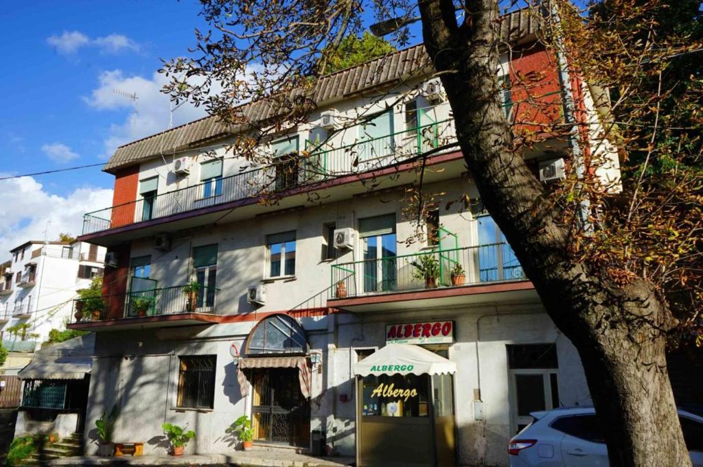 a white building with a balcony on top of it at Albergo Da Peppino in Poggio Mirteto