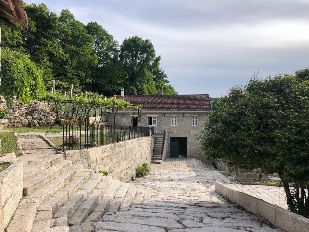 a stone stairway leading to a stone house at QUINTA do SOUTO BARCIADEMERA in Barciademera