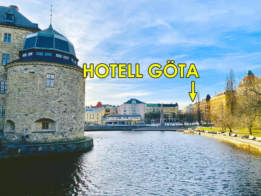 a building with a tower in the middle of a river at Hotell Göta in Örebro