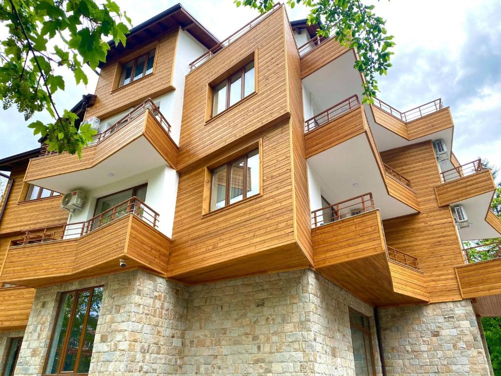 a building with wooden balconies on it at Kleptuzaparts in Velingrad