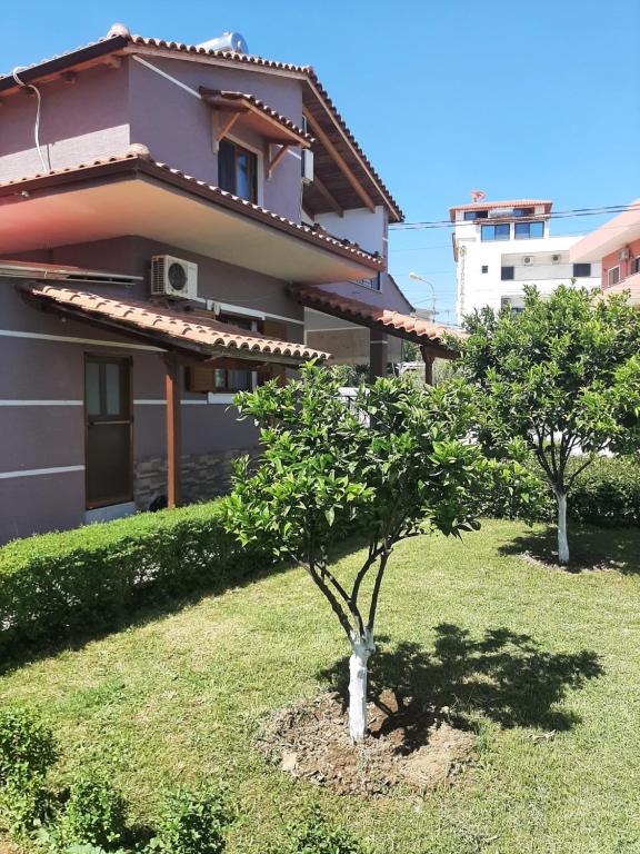 a house with two trees in front of it at Vila Melisa Ksamil in Ksamil