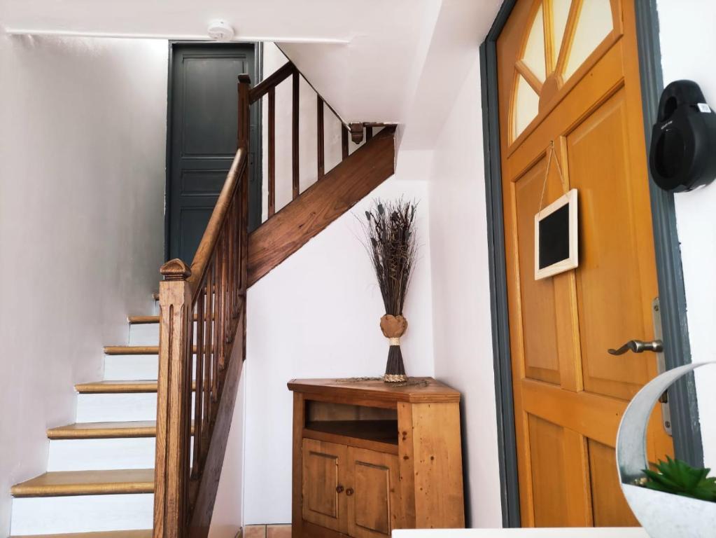 a staircase in a house with a wooden door at Résidence Le Refuge Toy - 2 appartements T2 dispo - Tout compris in Luz-Saint-Sauveur