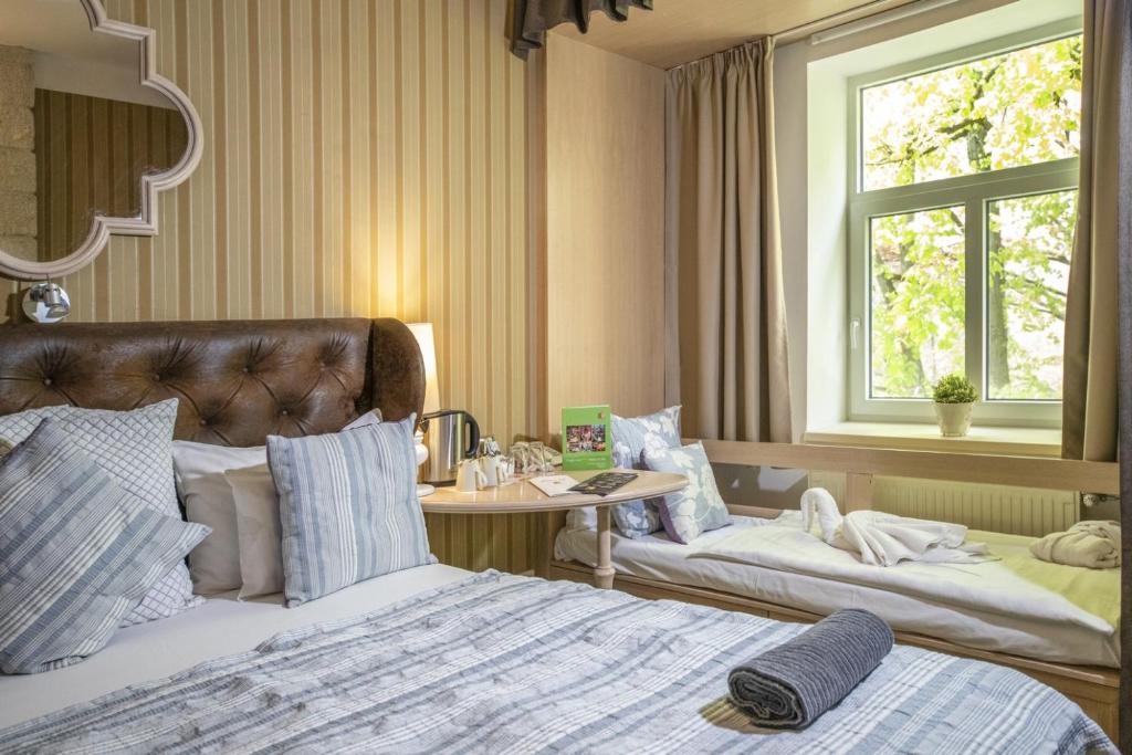 Postel nebo postele na pokoji v ubytování Oxigén Family Hotel Noszvaj