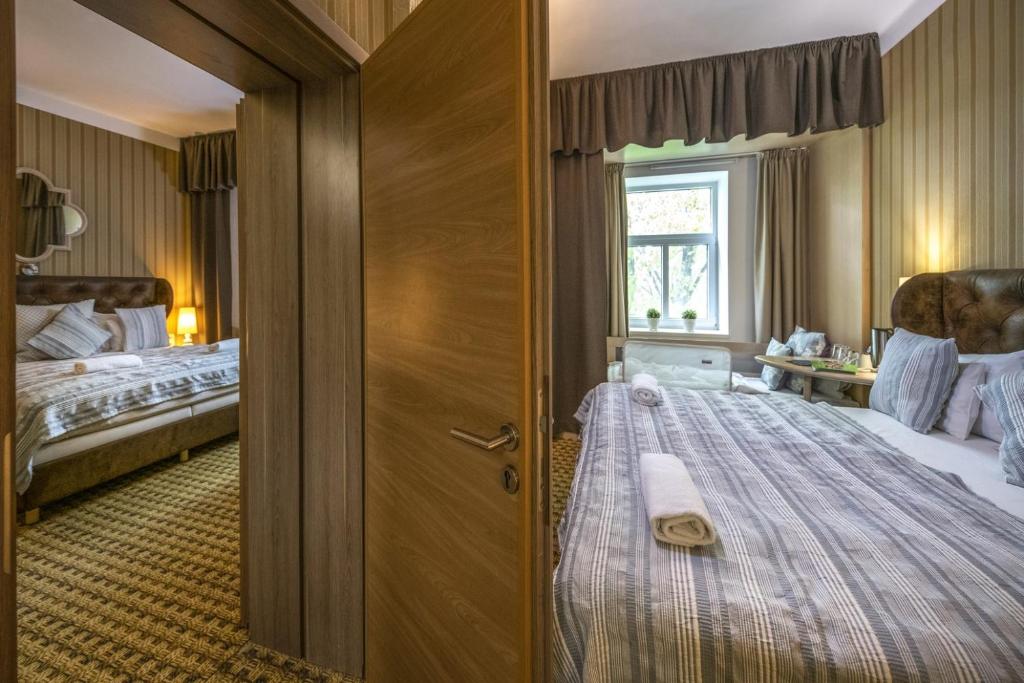 Postel nebo postele na pokoji v ubytování Oxigén Family Hotel Noszvaj