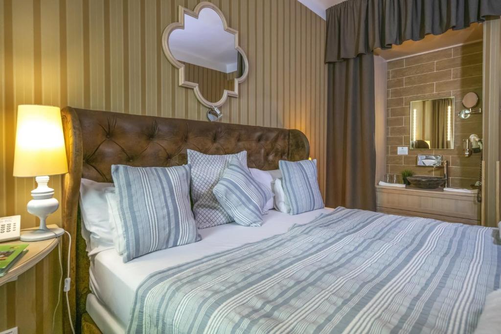 Postel nebo postele na pokoji v ubytování Oxigén Family Hotel Noszvaj