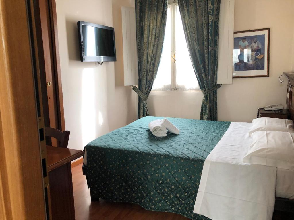 Postel nebo postele na pokoji v ubytování Hotel Le Due Fontane
