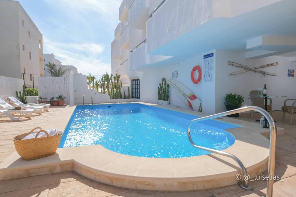 a swimming pool in the middle of a building at Apartamentos Ibiza in Colònia de Sant Jordi