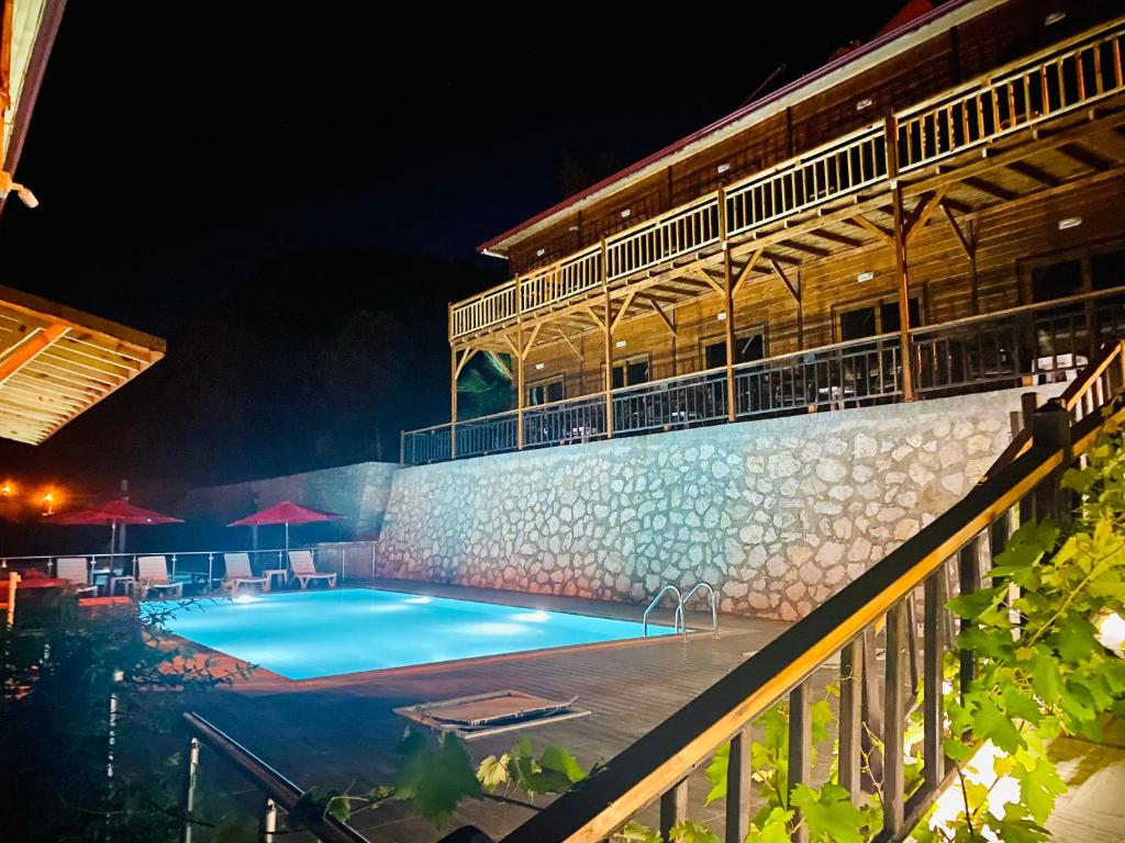 a swimming pool in front of a building at night at 7 Green Adrasan in Adrasan
