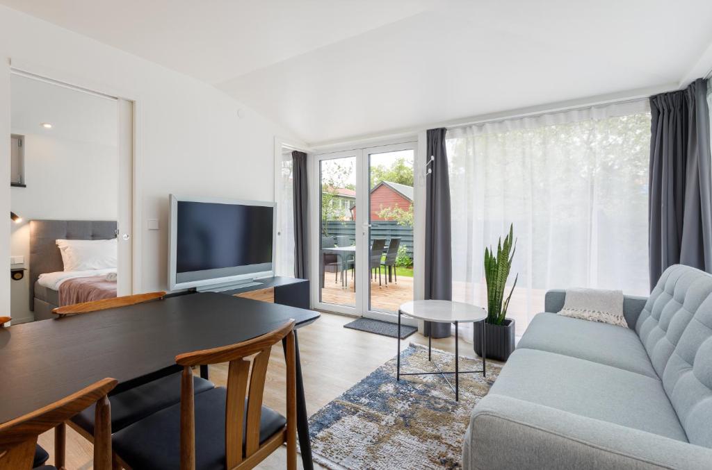 a living room with a couch and a table at Villa Aia Apartment in Pärnu