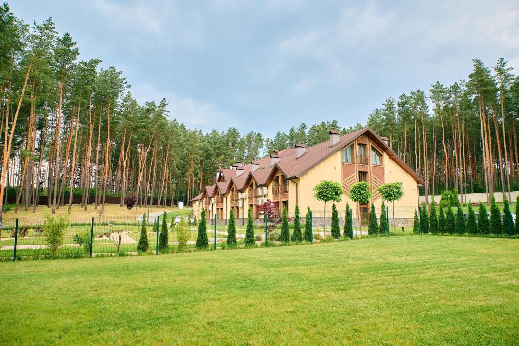 a large house in the middle of a field with trees at Kryve Ozero in Novoyavorivsk