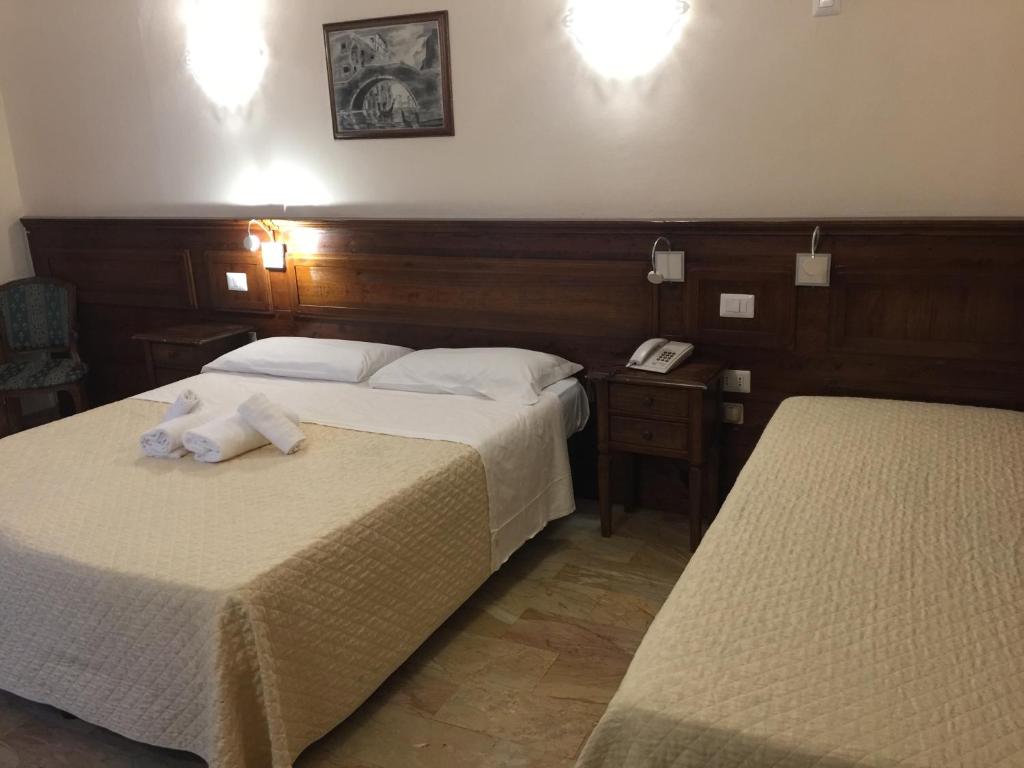 Postel nebo postele na pokoji v ubytování Hotel Le Due Fontane