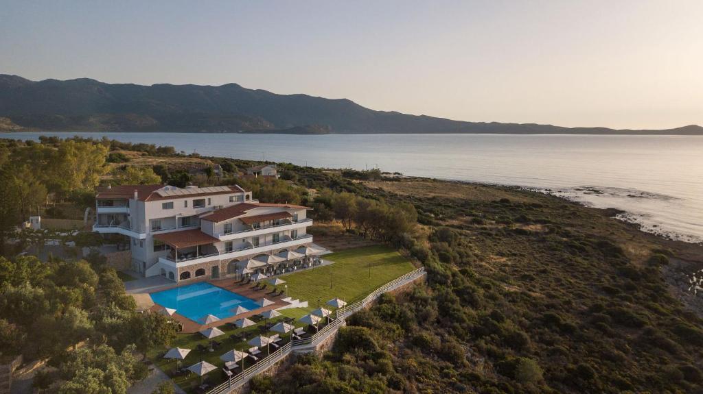 
a house on a hill overlooking a body of water at ALKINOI RESORT AND SPA in Monemvasia
