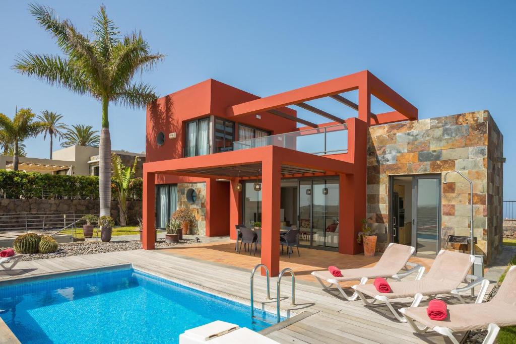 a house with a swimming pool in front of it at Las Terrazas Villa 3 in Salobre