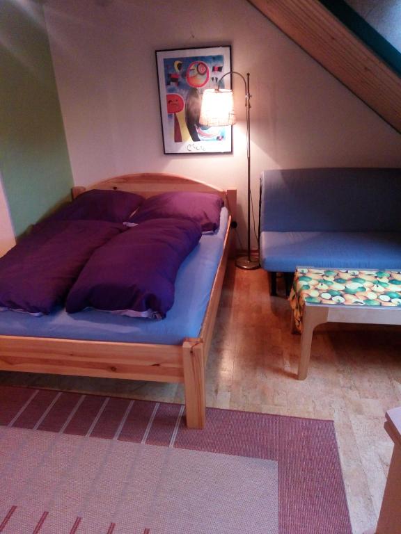 a bedroom with a large bed and a bench at Ohne Sorgen in Goslar
