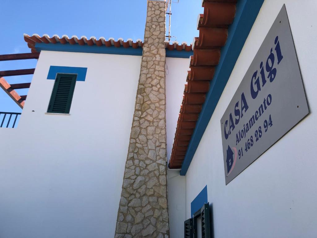 Una iglesia blanca con un cartel en el costado. en Casa GiGi en Sagres