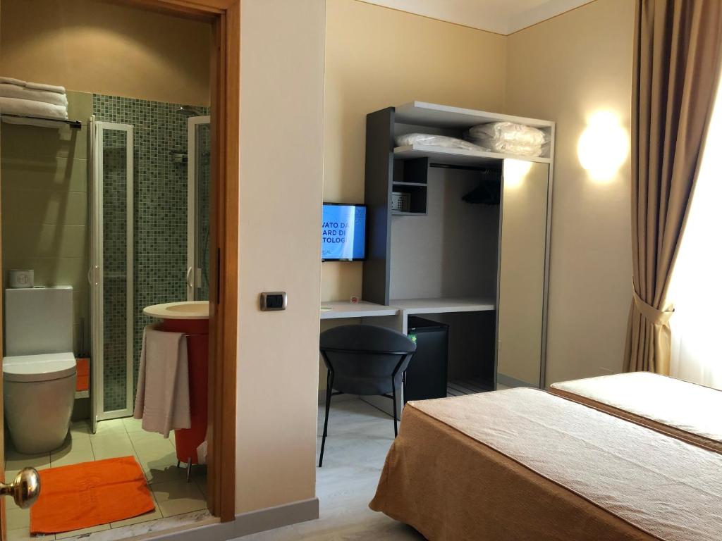 Säng eller sängar i ett rum på Hotel Tirrenia