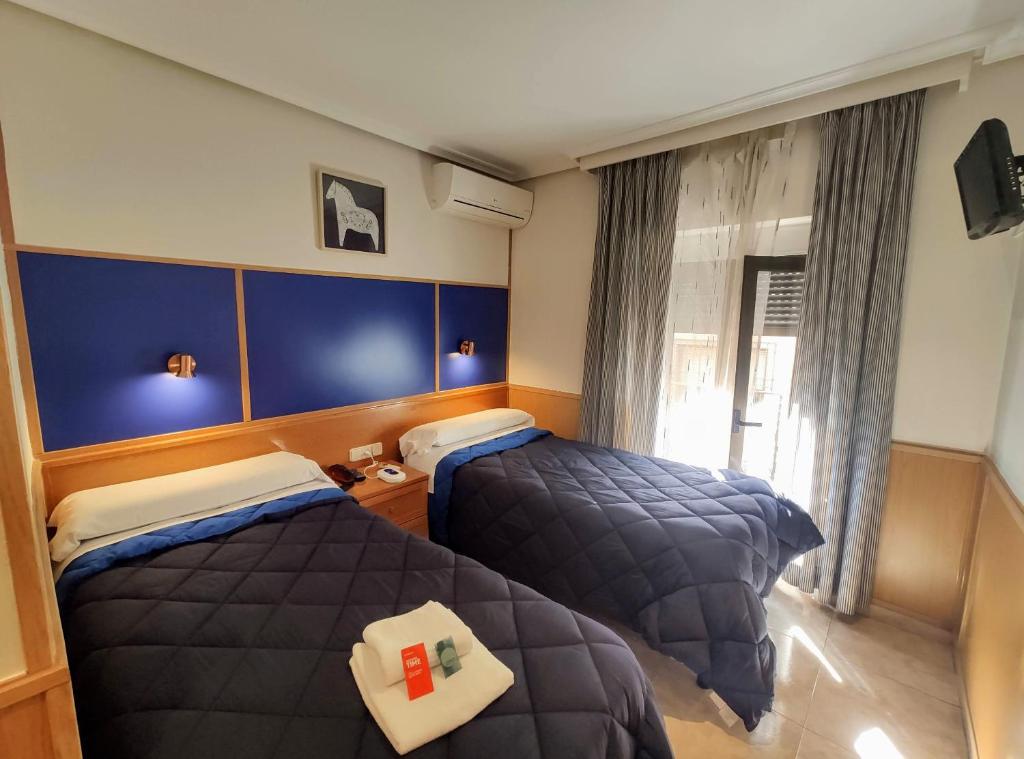 Postel nebo postele na pokoji v ubytování Trípolis Toledo