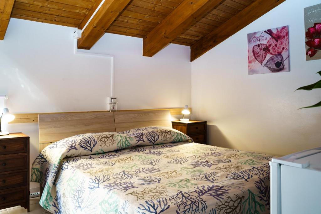 a bedroom with a bed and two night stands at Sansi´s Sapri Camere in Sapri