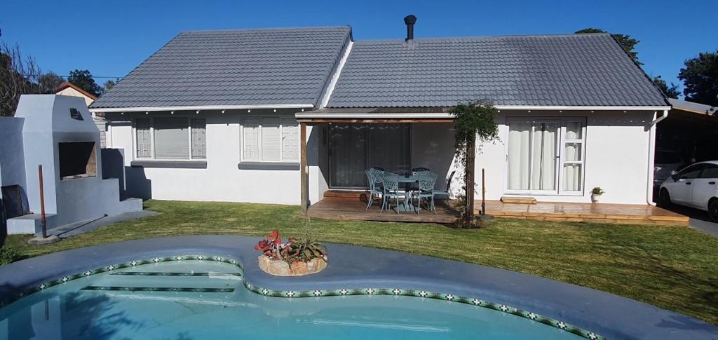 a house with a swimming pool in the yard at Fredericks in Plettenberg Bay