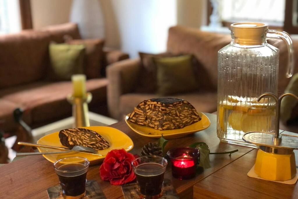 a table with two plates of cookies and a bottle at Comfy 3 Room House with Garden in Istanbul