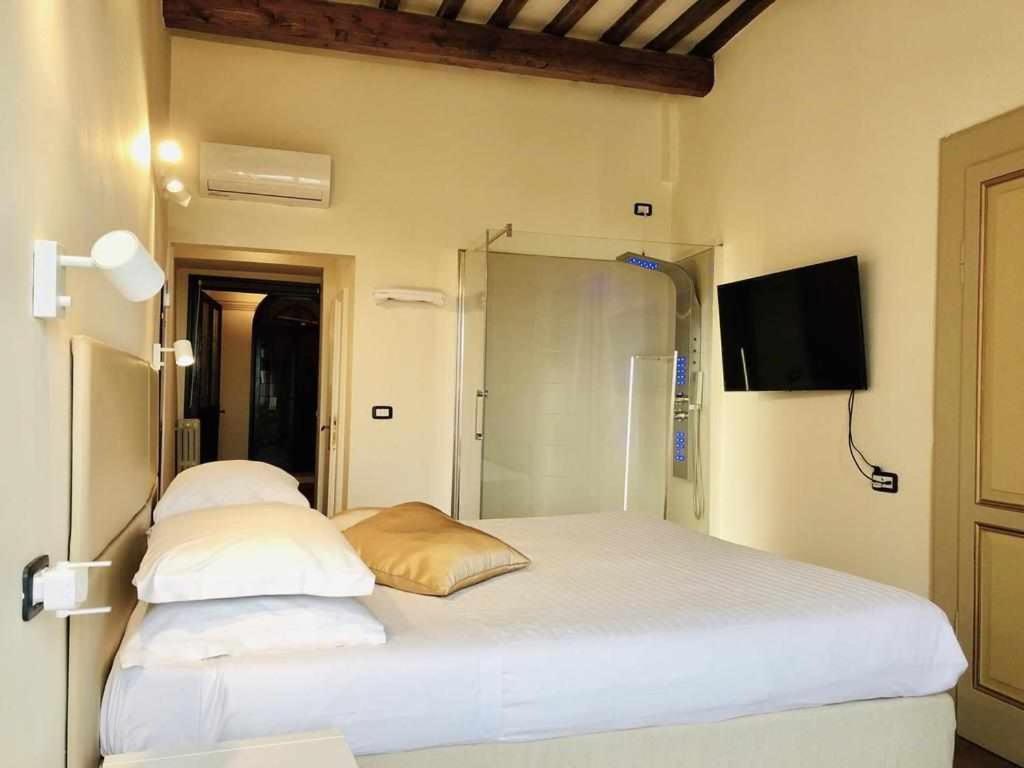 Posteľ alebo postele v izbe v ubytovaní Mavitur Rooms Assisi