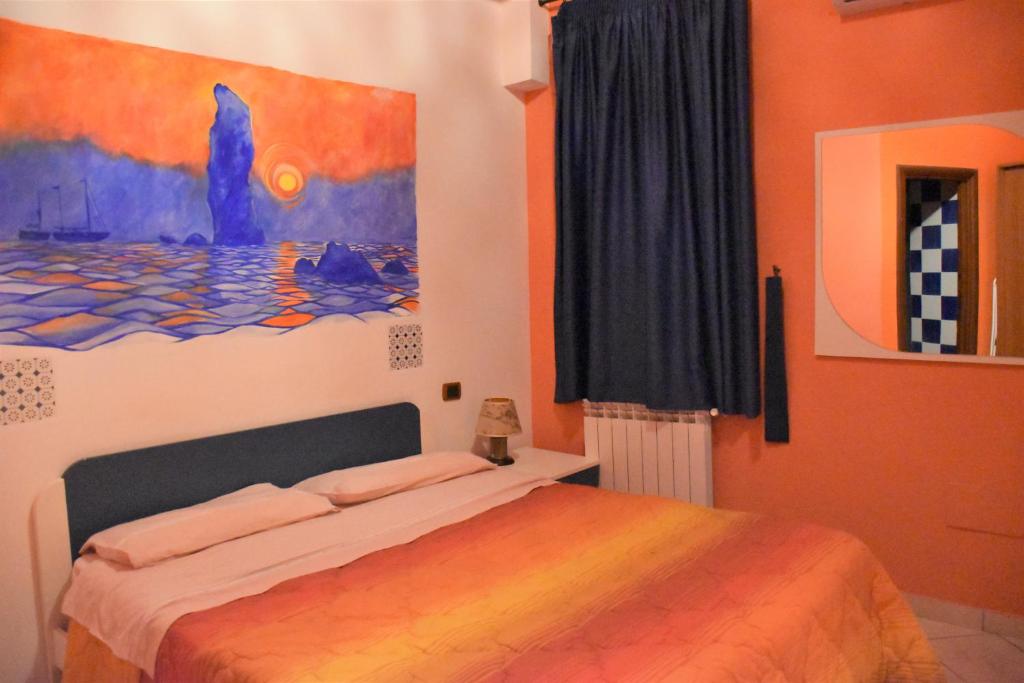 a bedroom with a bed and a painting on the wall at Le Soleil B&B in Milazzo