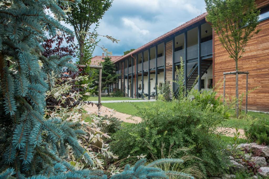 an external view of a school building with plants at Statek u Prahy in Škvorec