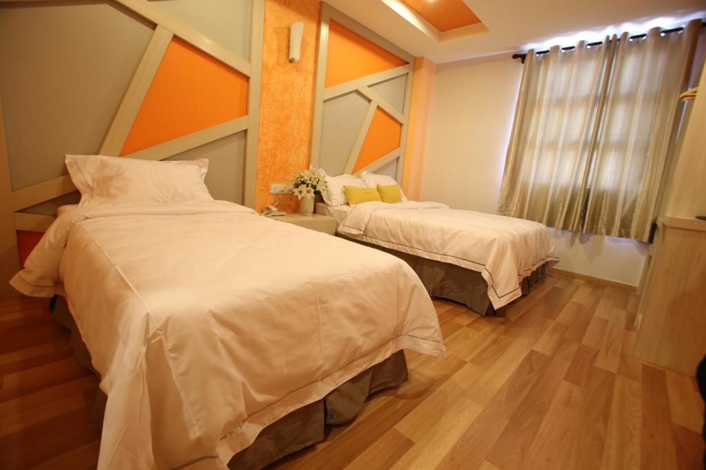 Postel nebo postele na pokoji v ubytování Sunshine Inn Plus