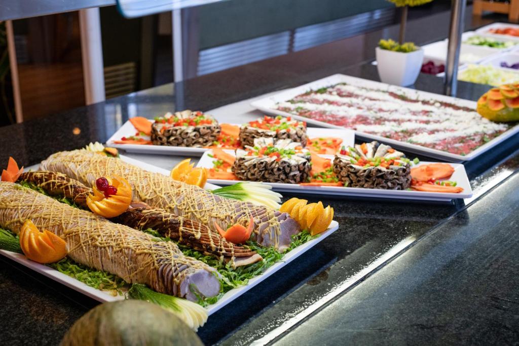 a buffet with several trays of food on display at Alexandre Grand Teguise Playa in Costa Teguise