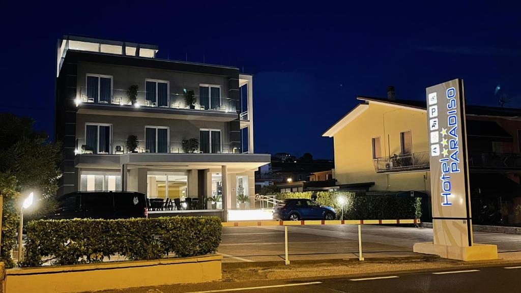 a building with a sign in front of it at Hotel Paradiso in Bardolino