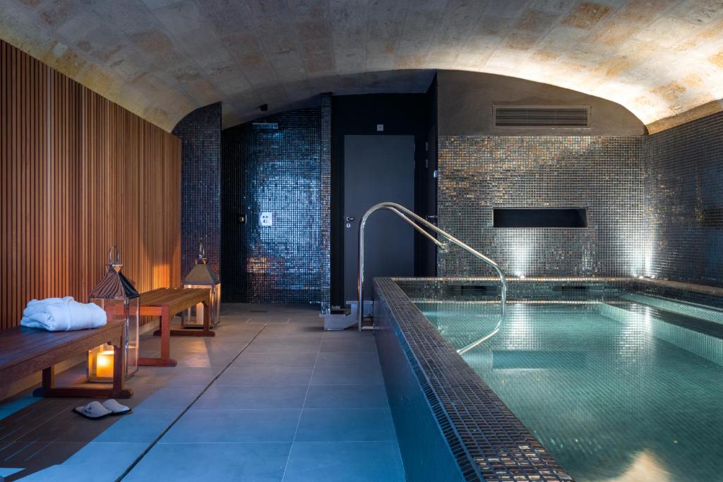 a bathroom with a large swimming pool in a building at Villas Foch Boutique Hotel & Spa Bordeaux in Bordeaux