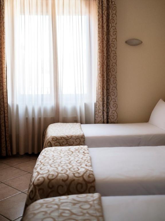 Postel nebo postele na pokoji v ubytování Hotel Lory