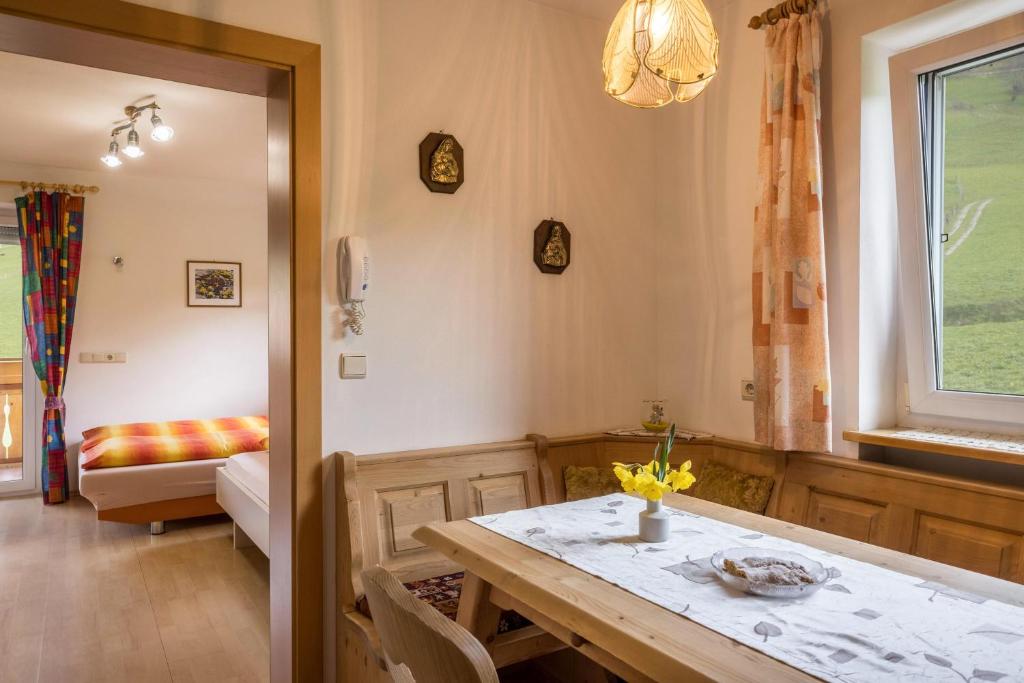 a dining room with a table and a couch at Ferienwohnung Kirchblick Gasser in Terento