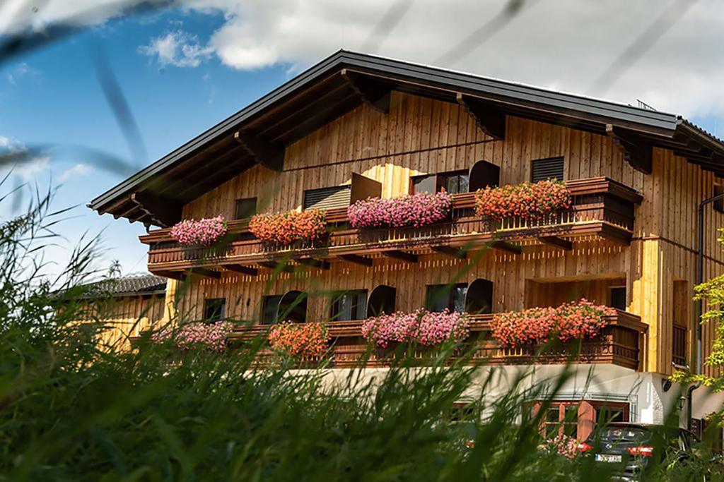 a building with flower boxes on the side of it at Gasthof Steinerwirt in Grossgmain