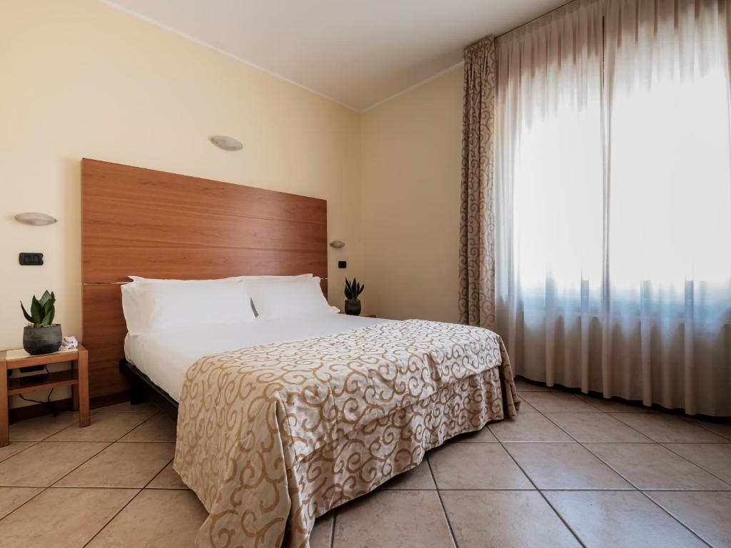 Postel nebo postele na pokoji v ubytování Hotel Lory