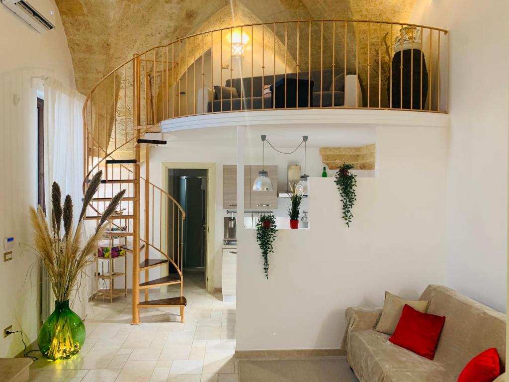 a living room with a couch and a staircase at Casa Vacanza indipendente 53 mq Puglia in Francavilla Fontana