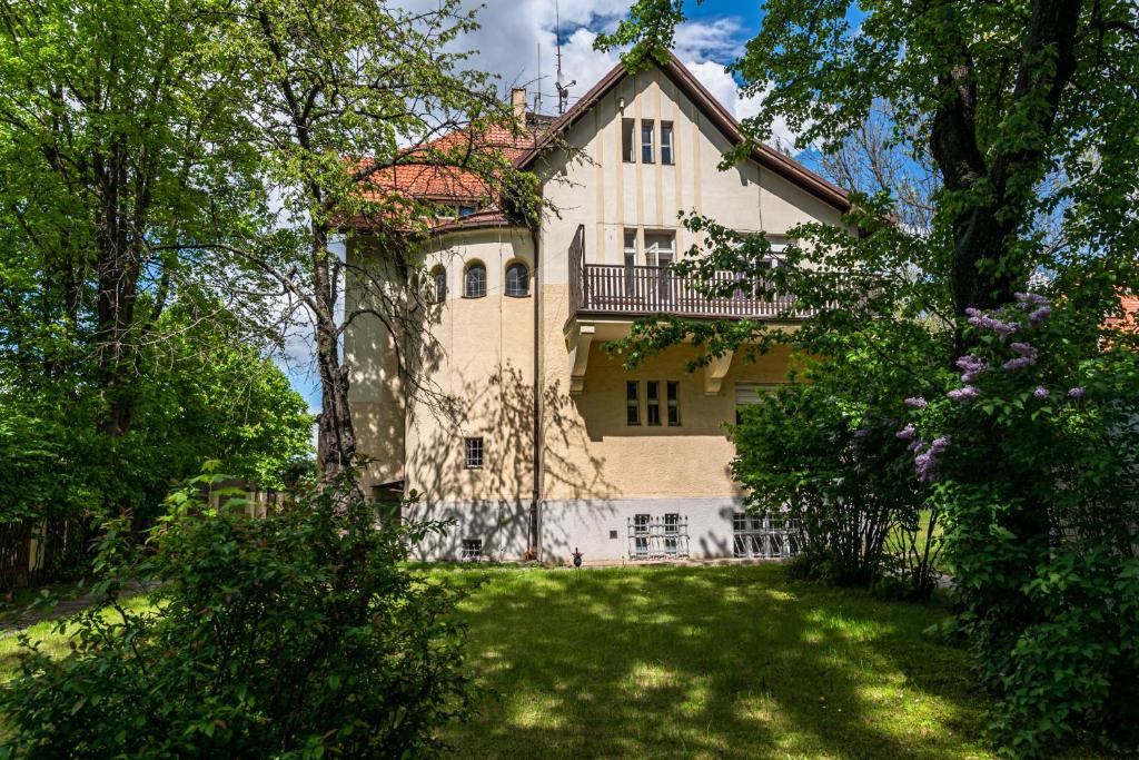 a large house in the middle of a yard at Historic Villa "Imperia" in Prague