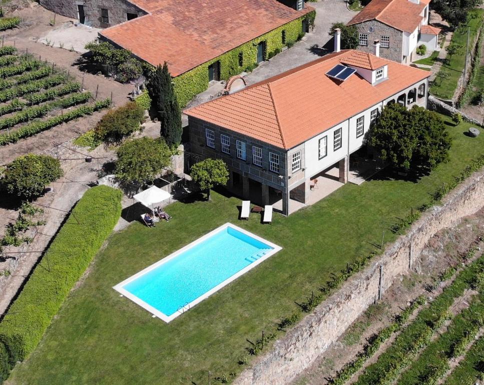 an aerial view of a house with a swimming pool at Quinta da Portela - Casa Visconde Arneiros in Lamego