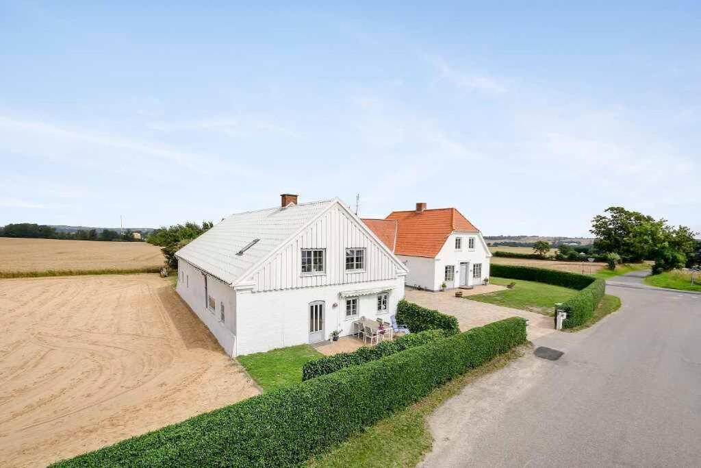 an aerial view of a white barn and a house at Big house in the countryside near UNESCO city in Christiansfeld