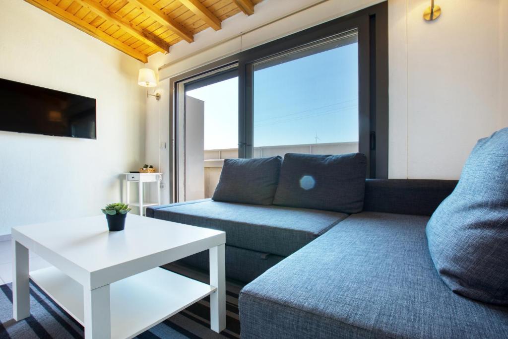 a living room with a couch and a table at AEGEAN Apartments - Marina & Chios Island View in Cesme