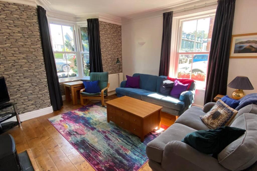 a living room with two couches and a coffee table at Poet's Corner - flat close to centre of Keswick in Keswick
