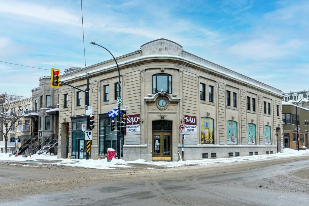 a building on the corner of a street with a traffic light at Huge New Flat well Located closed on St-Denis Street by Den Stays in Montréal