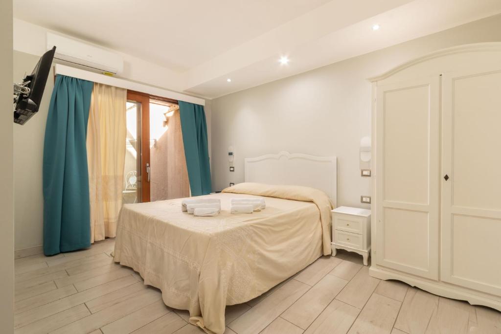 Postel nebo postele na pokoji v ubytování Domu Ajaju Guest House