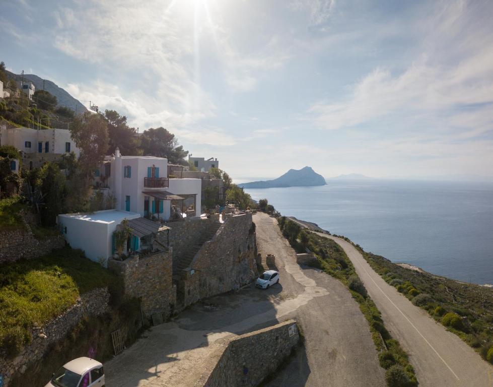 a view of the ocean from the side of a cliff at Uranos Studios in Amorgos