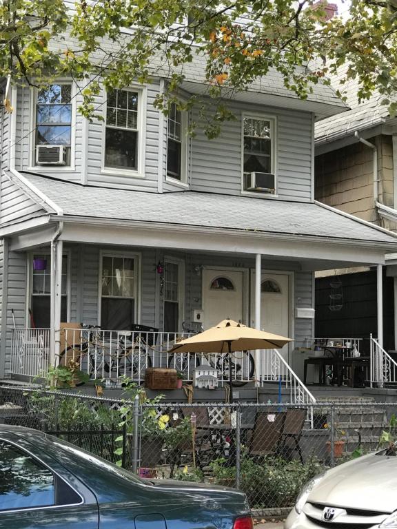 a house with a table and an umbrella in front of it at Classical American House 4 in Brooklyn